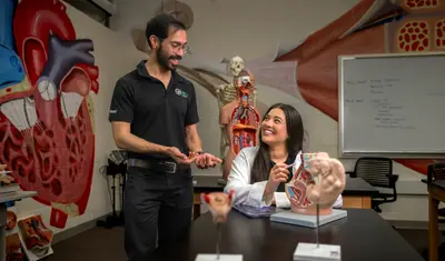 An anatomy professor and an anatomy student talking together