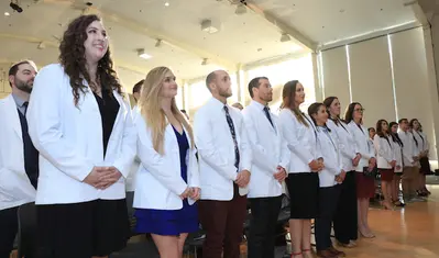 Students in the Master of Science Physician Assistant (MSPA) Program at CSUMB, shown here at their first White Coat Ceremony in December 2019, have joined hospital volunteer corps all over the country to help battle COVID-19.