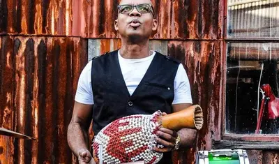Jesus Diaz holds percussion instrument