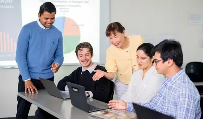 An accounting professor engages with students
