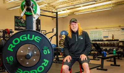 A man is posing for a photo in Gym