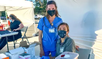 Physician assistant students Katy Yagorva and Ashley Miller were among the volunteers providing vital assistance at a Monterey County vaccine clinic at CSUMB.