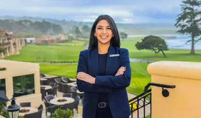 A girl in a blue blazer poses for a photo.