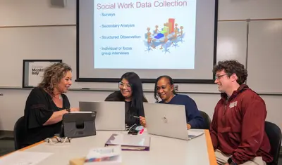 A group of social work credential students and professors smiling at the camera