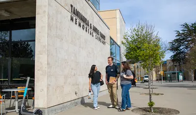Students standing outside the exterior of the library