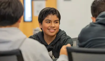 Student sitting with friends at a table