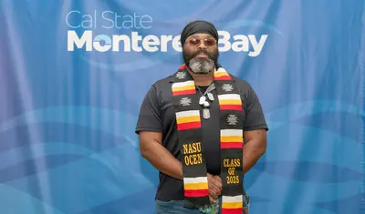 CSUMB student with his stole