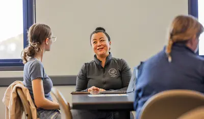 A staff member meets one-on-one with a student
