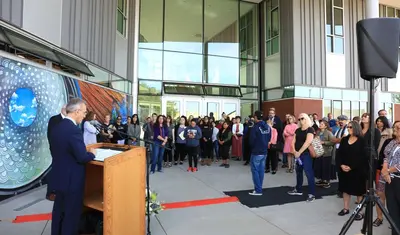President Eduardo M. Ochoa addresses the crowd gathered outside the new CAHSS building for a ribbon cutting ceremony in October 2019.