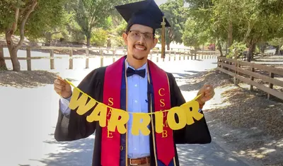 Martin Cisneros Jr. in his graduation cap and gown