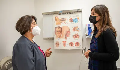 Nursing student and program director in exam room
