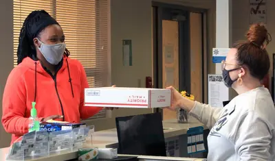 Kim McKinney, resident assistant, and Robyn DoCanto, coordinator of housing operations, are among the staff who remained on campus to serve students.