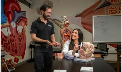 An anatomy professor and an anatomy student talking together