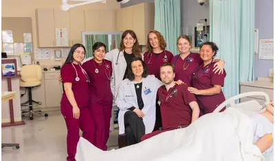 A group of nursing students and professors smiling at the camera