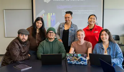 Group of students posing for a group photo in the classroom