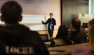 A professor giving a talk at Admitted Otter Days about a cipher