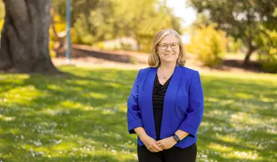 Karen Myers-Bowman standing on grass on the CSUMB campus.