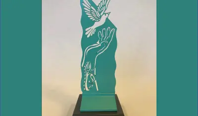 artist rendering of sculpture of hand releasing a dove sculpture