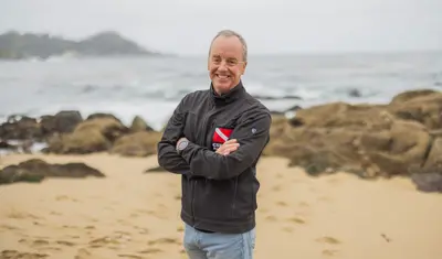 Portrait of a professor standing on the beach.