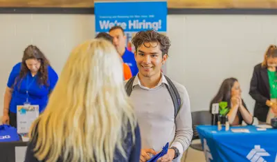 Student talking to an employer at a career fair.