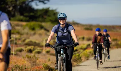 People cycling along the coast