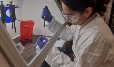 CSUMB science student Angela Albanese volunteers in the Monterey County Health Department lab to help test for COVID-19.