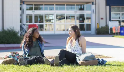 A photo of CSUMB students sitting in front of the University Center