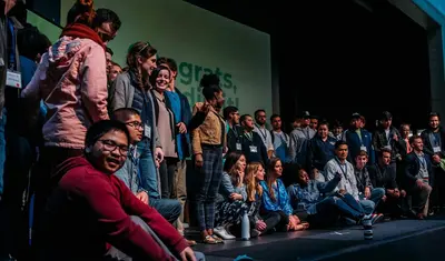 Group of students and community members networking and collaborating at an entrepreneurship startup event.