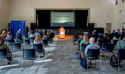 University leadership sit socially spaced apart at University Center