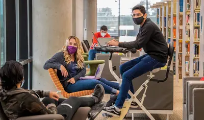 Photo: Masked students in the library
