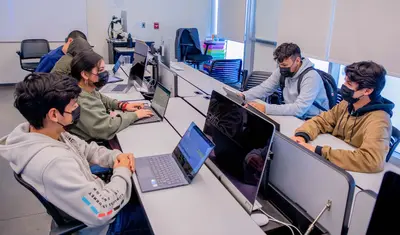 Photo: A group of CTI students on their laptops