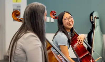 Cellist Averie Huang (right), 18, of Santa Cruz, gets tips on her playing from  Ameena Maria Khawaja during a California Orchestra Academy workshop