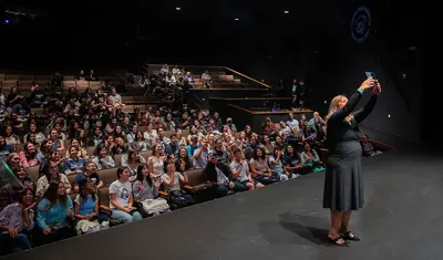 President Vanya Quinones takes a selfie with first-year students
