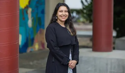 Melanie Mena smiles at camera 2023 Trustees Award Winner