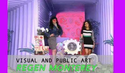 two women pose with art