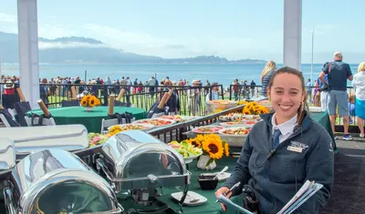 Intern Joanna Rivera-Arce manages a guest area at the 2023 Concours d'Elegance