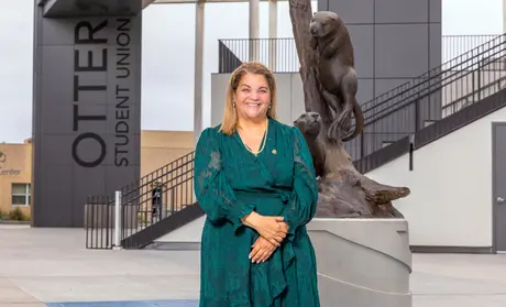 Vanya Quiñones in front of the Otter for Life statue - BDA
