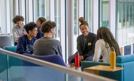 Students at College of Arts, Humanities and Social Sciences building