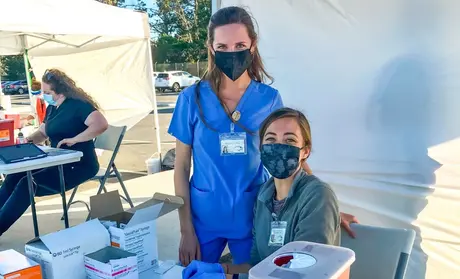 Physician assistant students Katy Yagorva and Ashley Miller were among the volunteers providing vital assistance at a Monterey County vaccine clinic at CSUMB.
