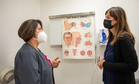 Nursing student and program director in exam room