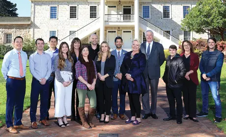 CSUMB alumni who are city of Monterey employees outside Colton Hall Museum with City Manager Hans Uslar (fourth from right). From left: Jay Punkar, Eric Palmer, Rafael Albarran, Kristonee Wade, Gundy Rettke, Jennifer Cleary, Ben Fowler, Paige Smith, Nat Rojanasathira, Wendy Davies, (Uslar), Vince Pizzo, Olga Maximoff and Jordan Leininger.