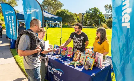 CSUMB staff talk to a parent and prospective student at 2025 Open House