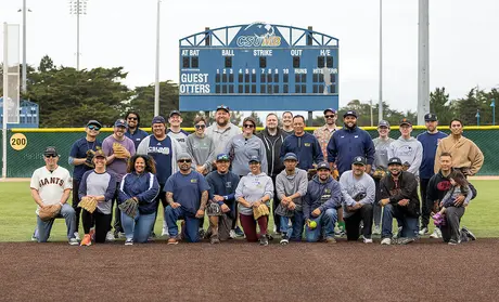���Ķ���vlog staff posing on the softball field after the employee softball game.
