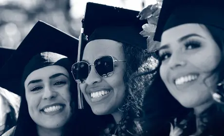 Graduates smiling during commencement
