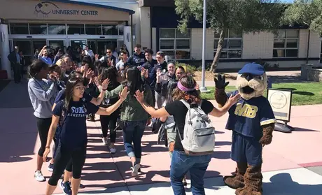 Photo: New students being greeted on their way to the University Center
