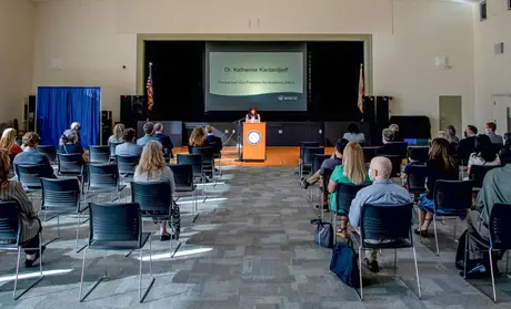University leadership sit socially spaced apart at University Center