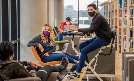Photo: Masked students in the library