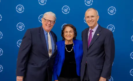 Monning, Huerta and Ochoa in front of CSUMB backdrop