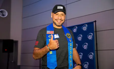 Student gives a thumbs up to the camera after the Veterans Stole Ceremony.