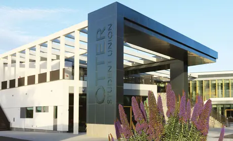 Photo: Exterior of the OSU building with purple flowers